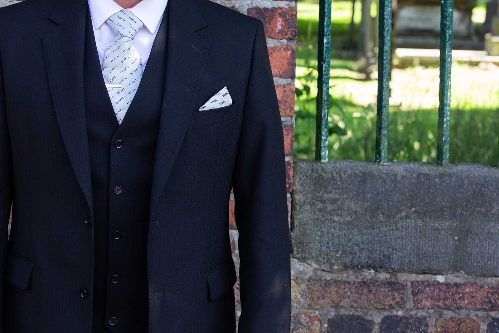View of Hopkinson Wootton Lovatt funeral director jackson and waistcoat outside church